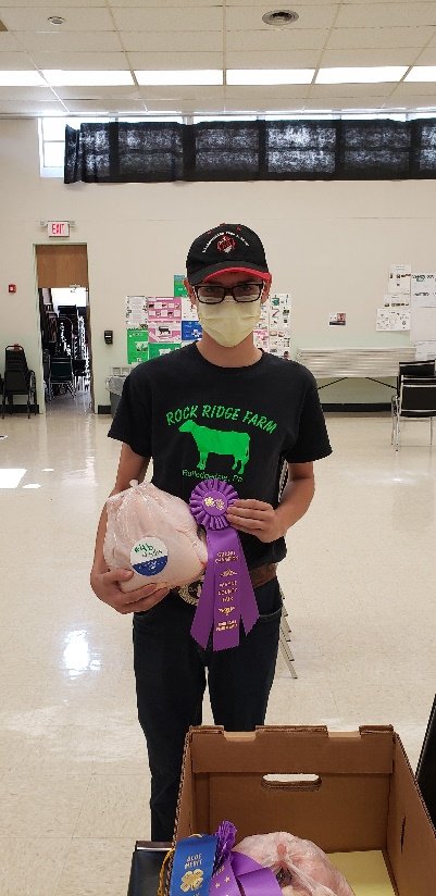 Bethany 4-H Club's Drew Rutledge with his grand champion 4-H meat bird project.